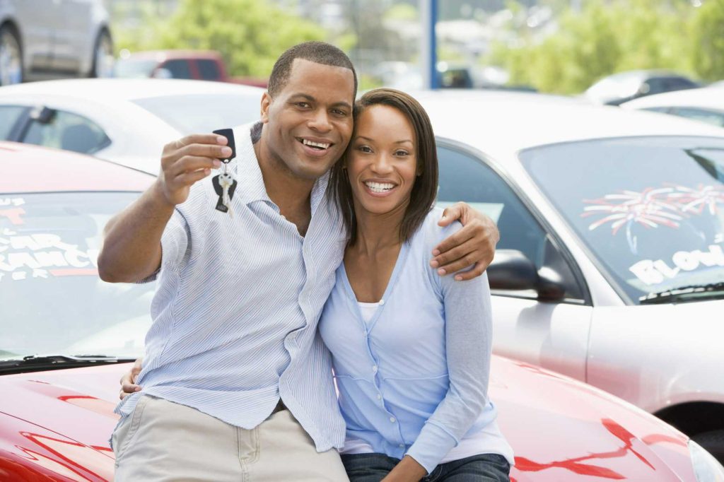 Couple showing new set of car keys